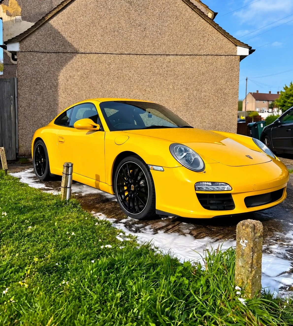 Yellow Porsche 911 Carrera after detailing, three-quarter front view