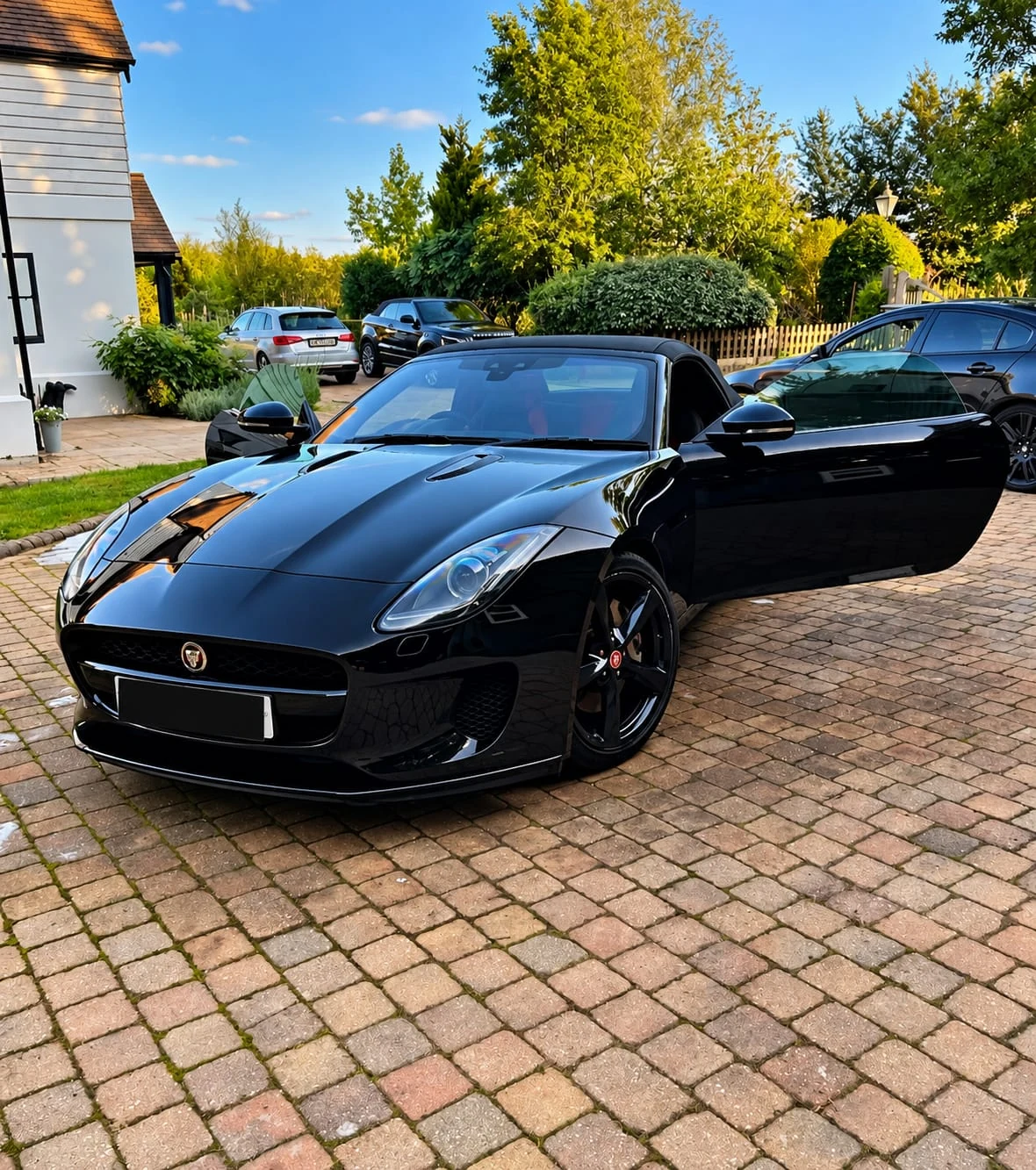 Black Jaguar F-Type after detailing, driver's door open